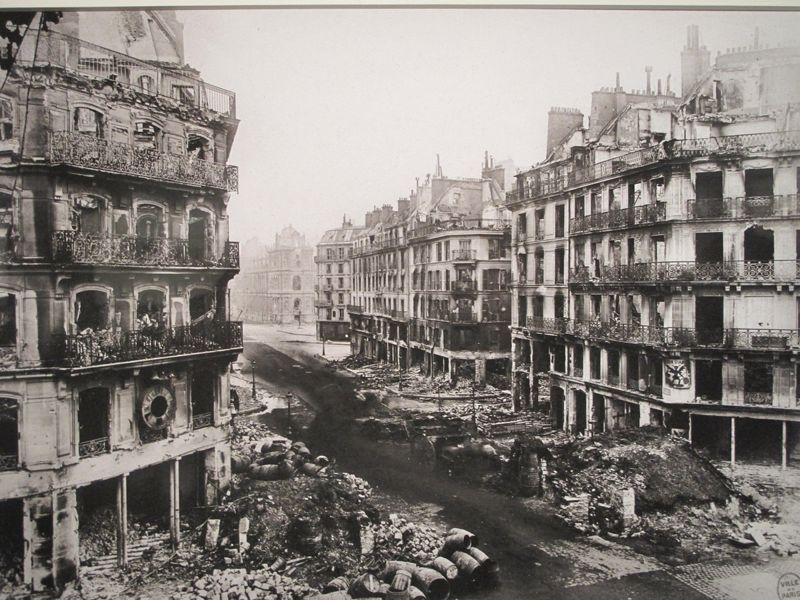 Ruined buildings and rubble along a Paris street
