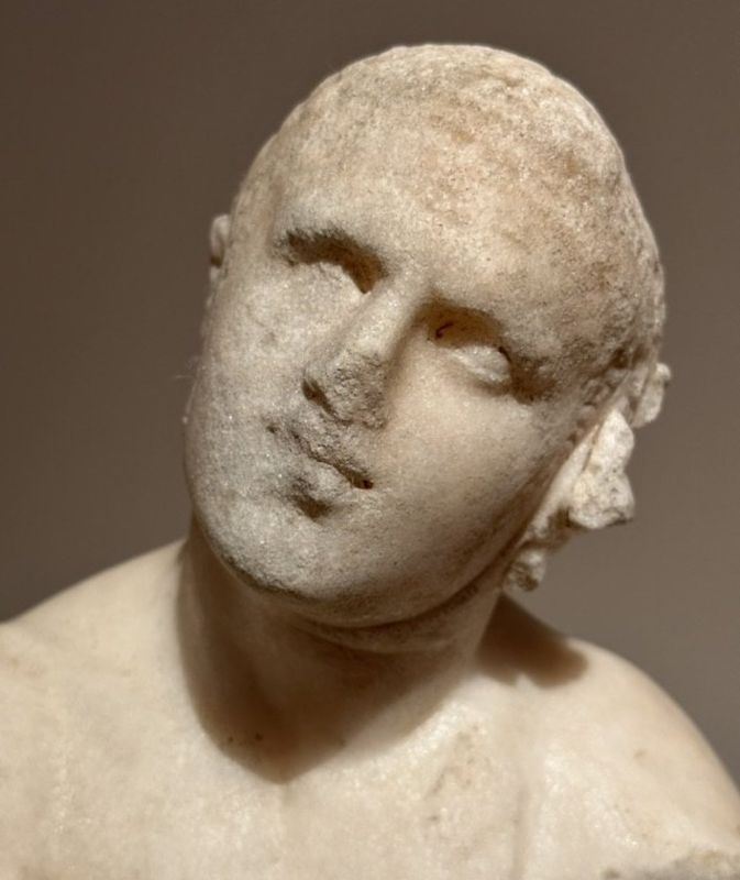 Small marble statue of an athlete.