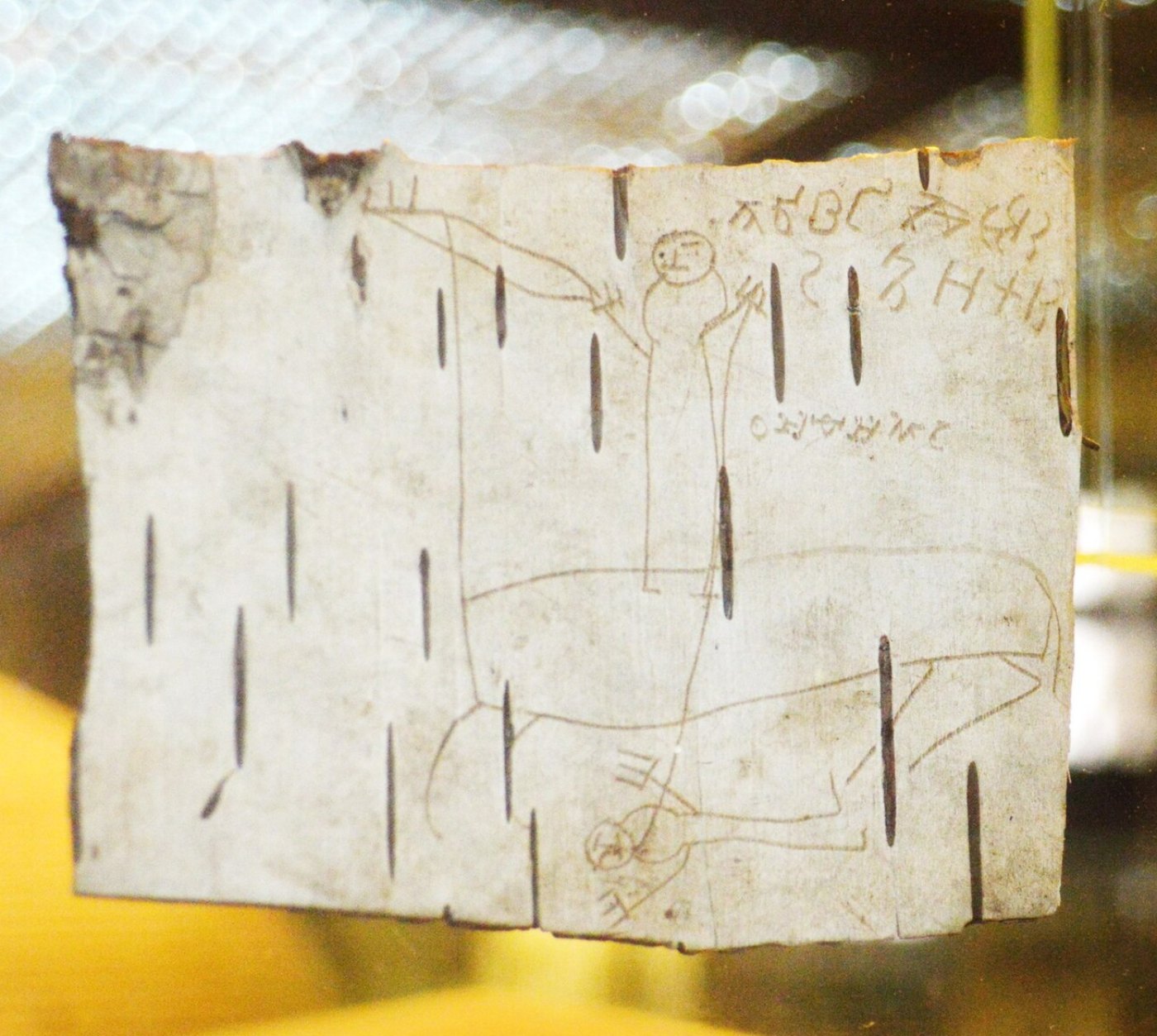 Onfim, a boy of Novgorod: birch bark document no. 200, with a rider spearing a fallen enemy and alphabet exercises. Mid-13th century.